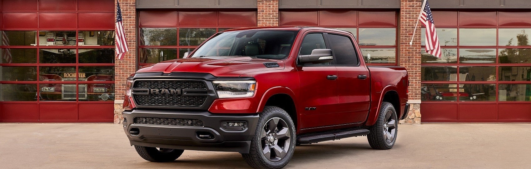 Red Ram truck parked in front of a garage