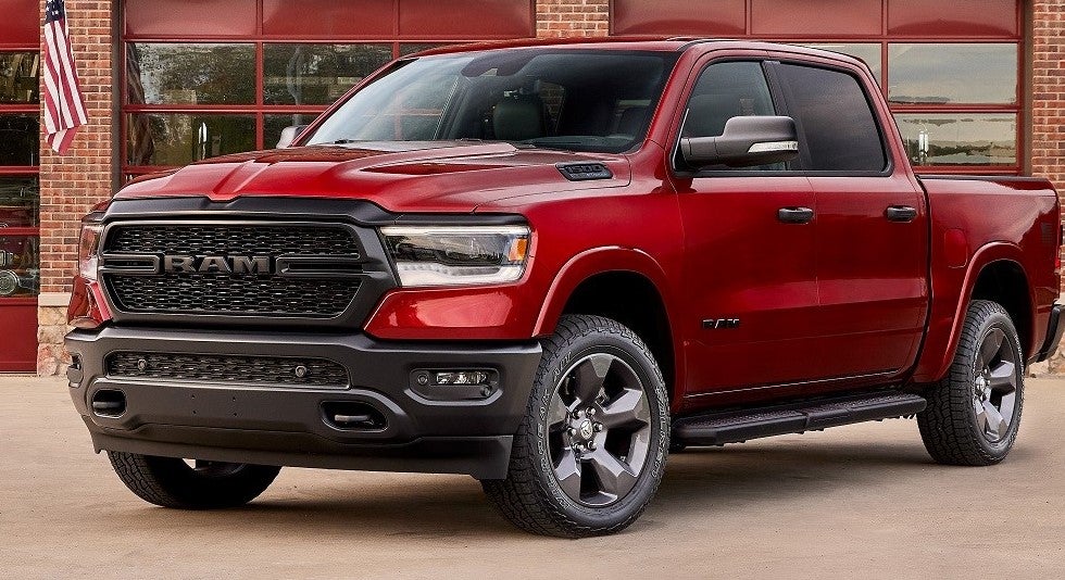 Red Ram truck parked in front of a garage